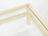 a glass table with a wooden frame on top of it