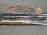 a lot of comic books stacked on top of each other