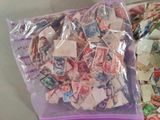 a bag full of postage stamps sitting on a table