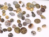 a lot of coins that are on a white surface