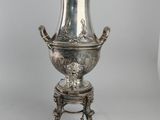 an antique silverplated coffee urn on stand with lid