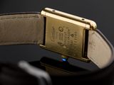 an image of a close up of a watch on a black surface
