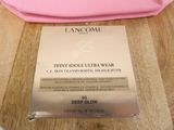 a pink bag sitting on a table next to a pink purse