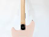 an electric guitar on a tripod stand against a white background
