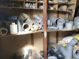 many different types of pipes and fittings on the shelves