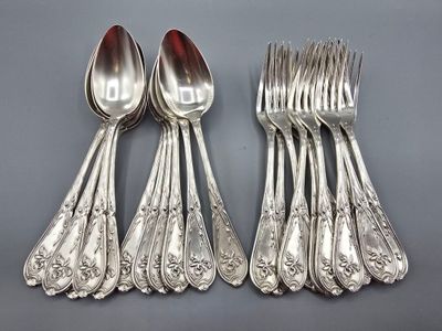 six silverplated spoons and six forks on a gray surface
