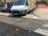 a white van that is parked on the side of the road