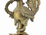 brass statue of a bird on a pedestal with a bird on it ' s head