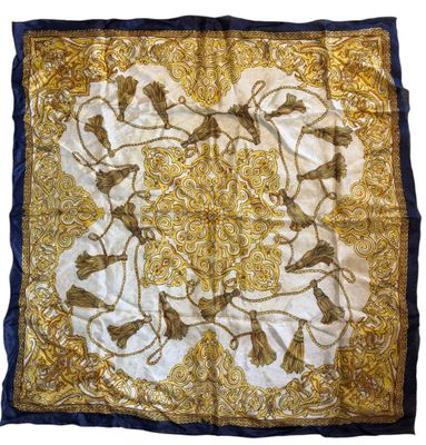 a gold and blue silk scarf with a picture of horses on it