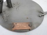 a small metal object with a tag on it