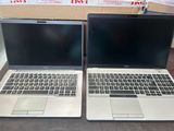 deux ordinateurs portables posés côte à côte sur une table
