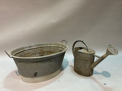 pair of antique metal watering cans with handles and handles