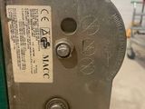 a close up of a metal device with a tag on it