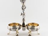 pair of silver plated candlesticks with a crown on the top