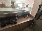 a kitchen with a sink and a mirror in it