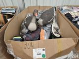 a cardboard box filled with assorted items and a tennis racquet
