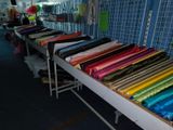 many different colors of fabric on a table in a store