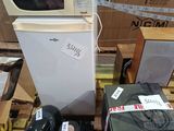 a microwave and other appliances on a pallet in a store