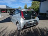 a small silver car parked in a parking lot