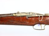 an old rifle with a wooden body and a metal handle