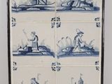a picture of a blue and white tile with pictures of people in boats