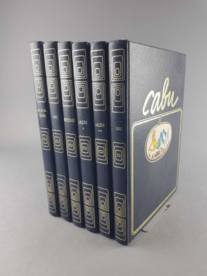 the four books are lined up in a row on a gray surface