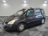 a picture of a small blue van parked in a garage