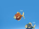 two colorful fish shaped brooches are shown against a blue background