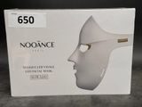a box with a white mask on it on a table