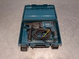 a blue tool box with a cord and a drill in it