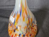 a glass vase with a multicolored design on it