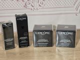 three boxes of lancome cosmetics sitting on a table