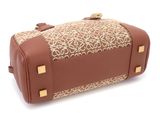 the brown and beige bag is sitting on a white surface