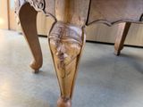 a wooden table with a carved face on top of it