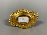 a close up of a gold plate with a label on it