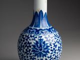 a blue and white vase that is sitting on a table