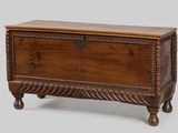 a wooden chest with a decorative design on the top