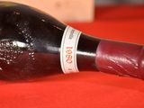 a bottle of wine sitting on a red table cloth