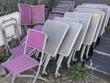 a lot of chairs that are outside of a building