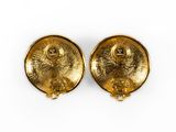 a pair of gold earrings on a white background