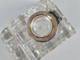 a glass object with a metal ring on top of it