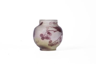 a small vase with a painting on it sitting on a table