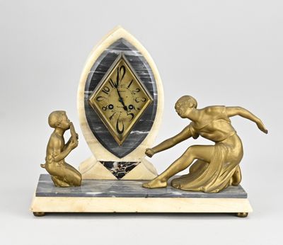 a statue of a man and a woman playing with a clock