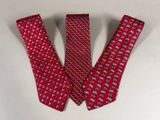 two red neck ties with elephants on them on a white surface