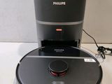 a close up of a robot vacuum on a counter with a charger