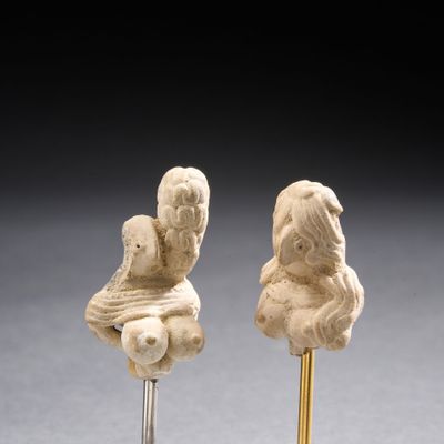 paire de petites statuettes représentant une femme tenant un bébé au bout d'un bâton