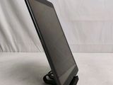 a tablet computer sitting on a stand on a white surface