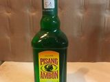 a bottle of green liquid sitting on a table