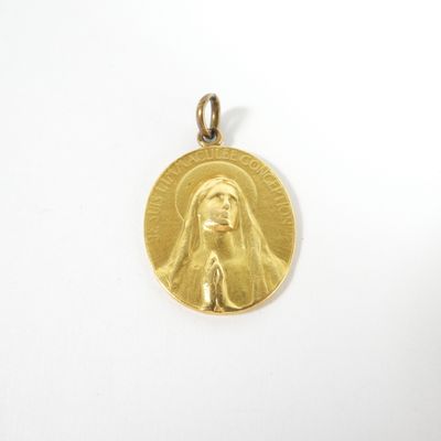 a close up of a gold medal on a white surface