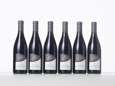 six bottles of red wine lined up in a row